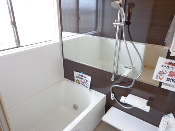 Bathroom. Unit was bus exchange. It features a large shower head.
