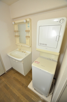 Washroom. Washing machine in the room and shampoo dresser