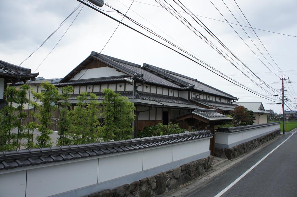 Local appearance photo. Local (10 May 2012) shooting full-scale wooden house cypress building
