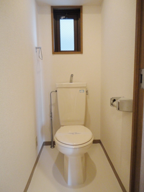Toilet. There is a window in the toilet. 