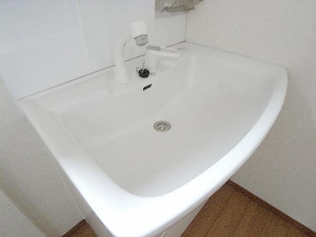 Wash basin, toilet. TV monitor phone