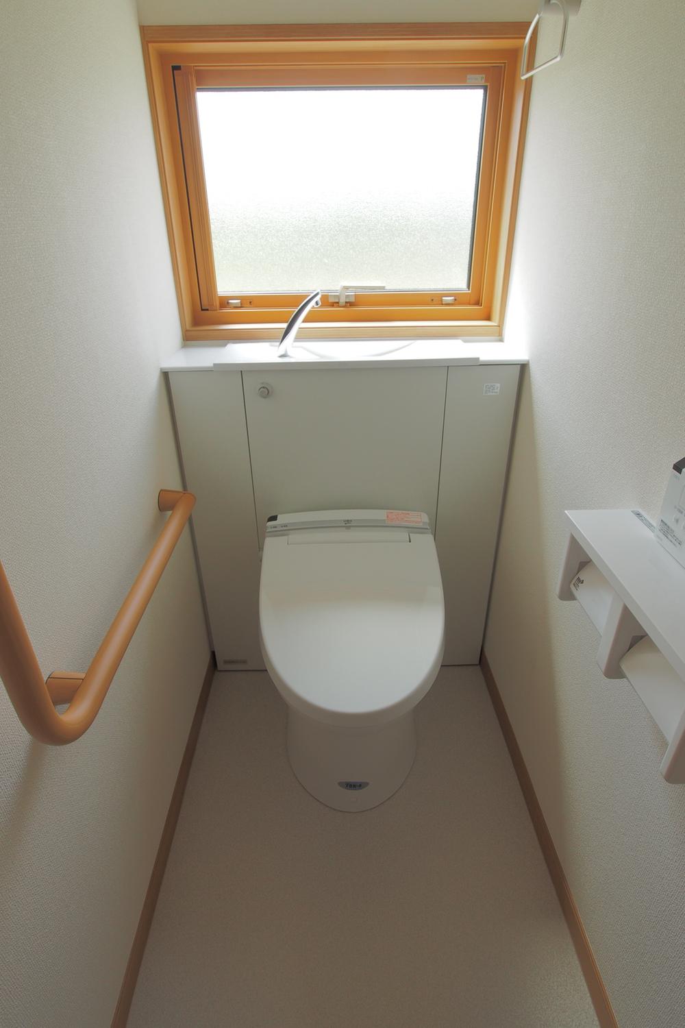 Toilet. With in-room hot water cleaning toilet seat