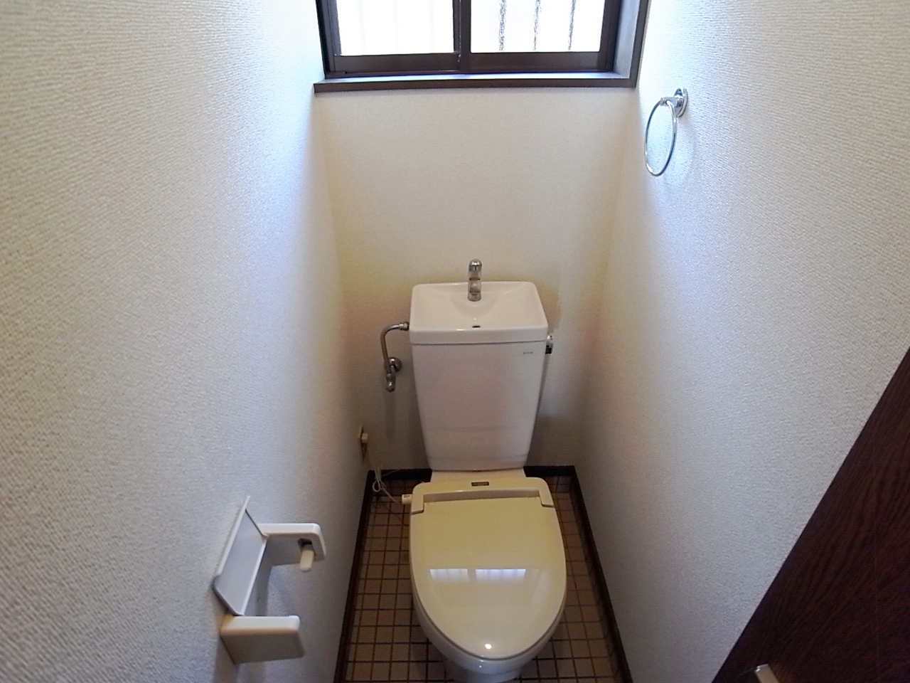 Toilet. It has a window in the toilet. 