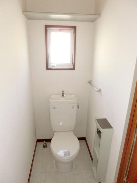 Toilet. Small window with toilet