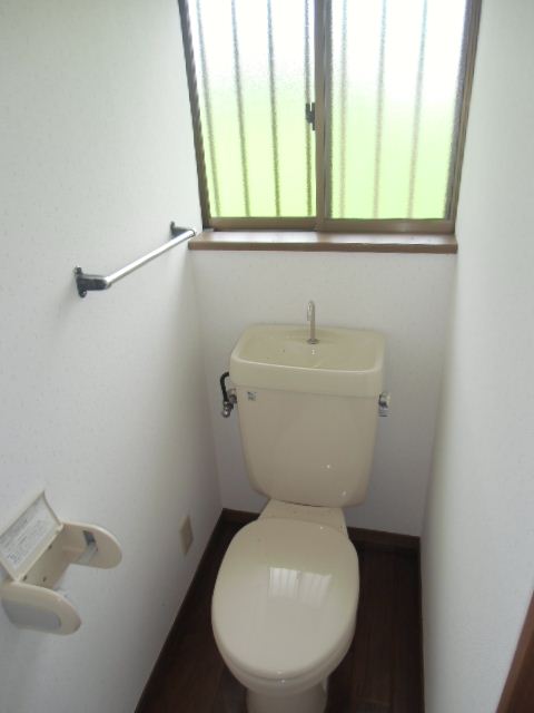 Toilet. There is a small window