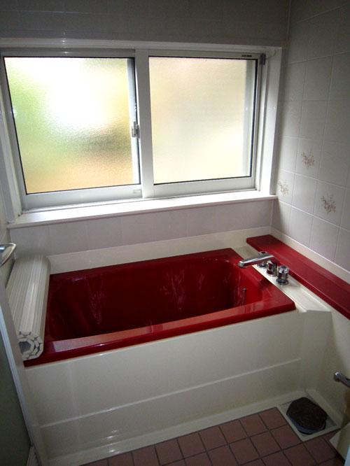 Bathroom. Wine red color of the bath