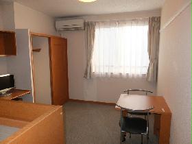 Living and room. It is a photograph that was taken from the room entrance