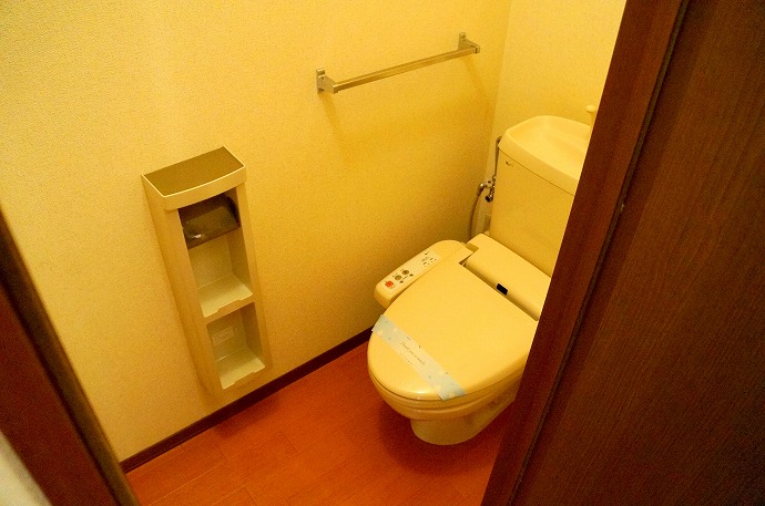 Toilet. Bidet and storage rack is attached