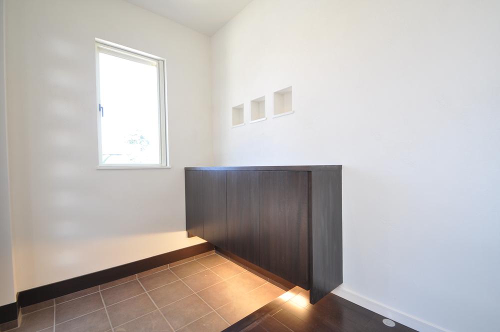 Entrance. Shoes cloak the entrance marked with indirect lighting. 