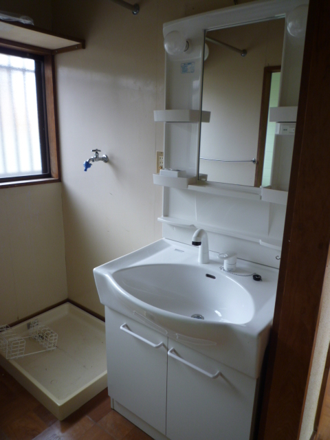 Washroom. Washbasin with shower ・ There Laundry Area