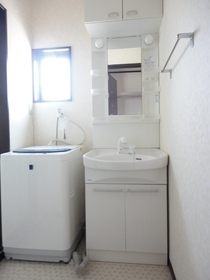 Washroom. Shampoo dresser. Washing machine with. 