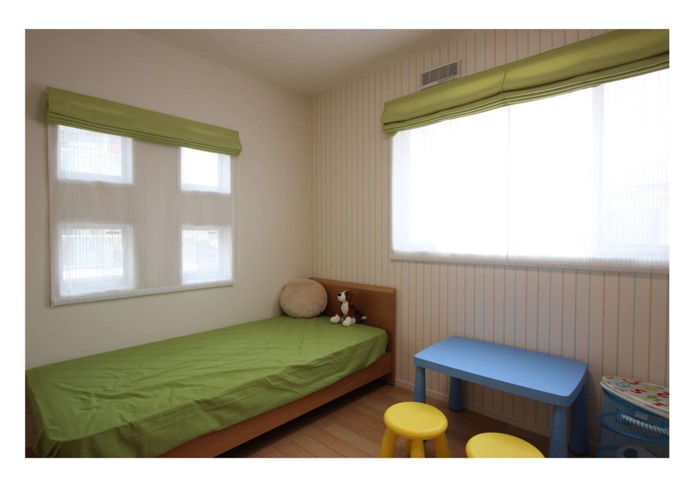 Non-living room. Is a children room with the image of a boy in the room. 