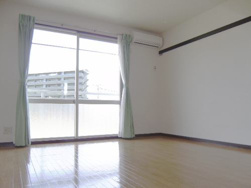 Other room space. It is a bright room with large windows