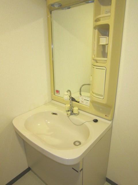 Wash basin, toilet. Basin is the vanity of the shower