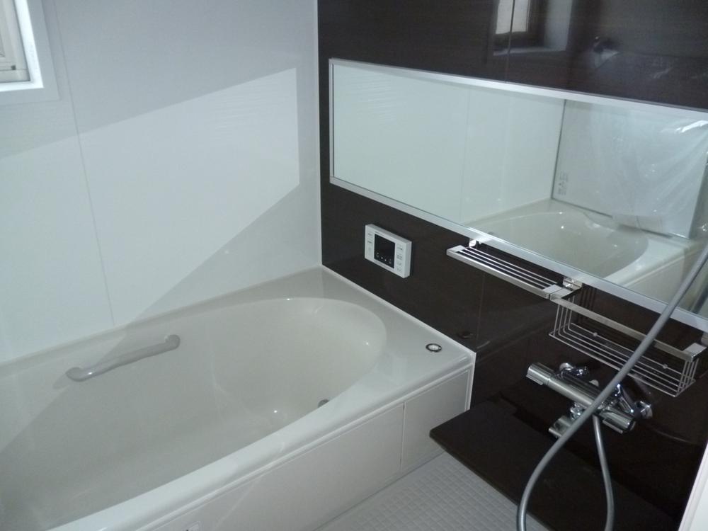 Bathroom. Since the mirror is large, Bathroom and is felt more widely.
