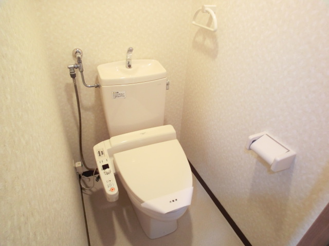 Toilet. It is a photograph of the other in Room. 