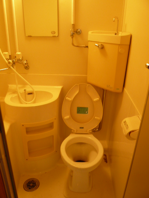 Toilet. It is a photograph of another in Room of the same type of room. 