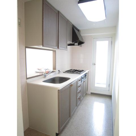 Kitchen. It is face-to-face kitchen with window. Refrigerator storage rooms