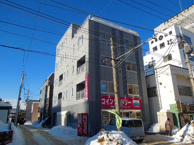 Building appearance. Coin-operated laundry is in the business on the first floor