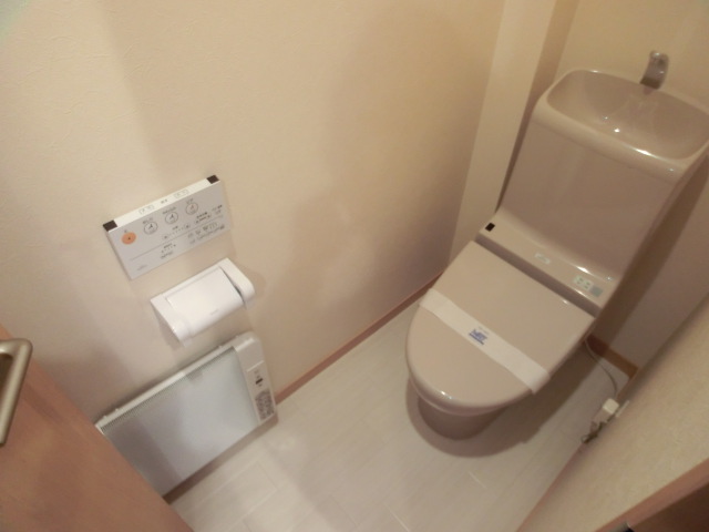 Toilet. With warm water washing toilet seat! 