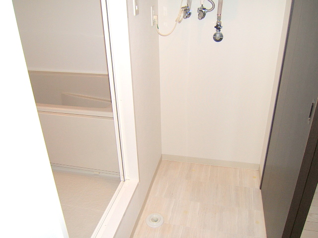 Washroom. With washing machine Storage