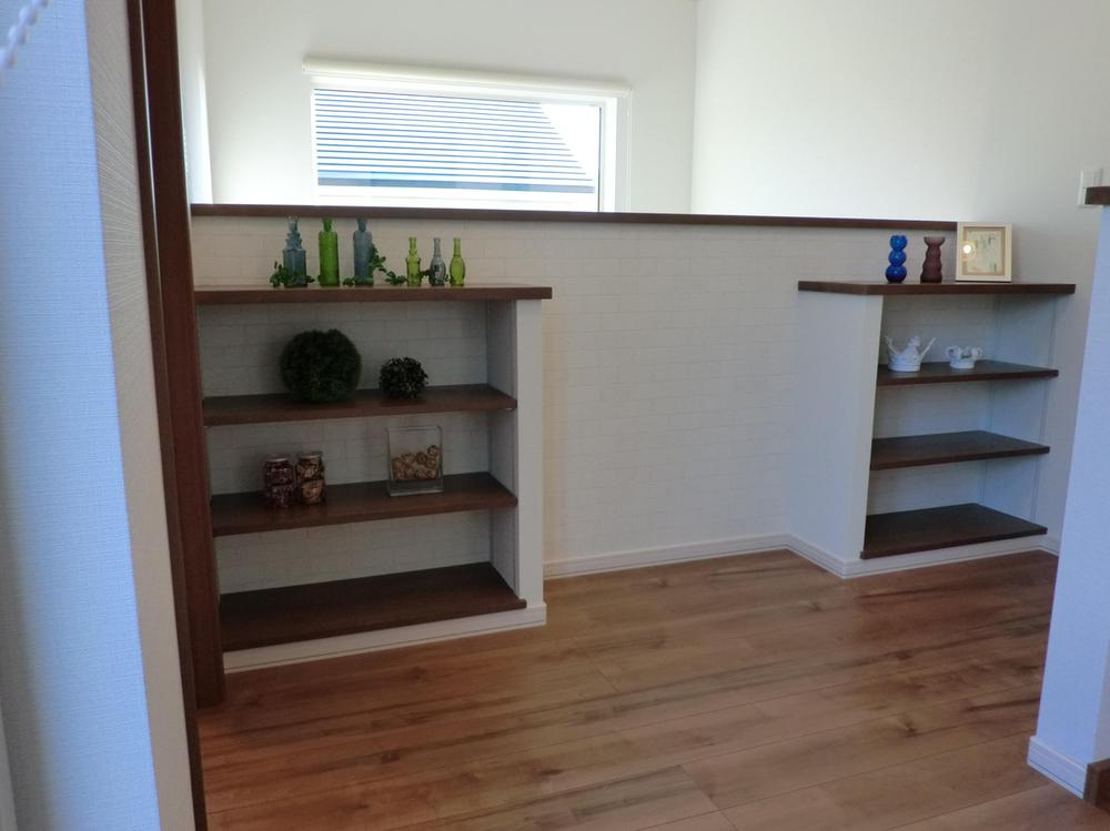 Other introspection. On the second floor hall facing the atrium is, Fixtures shelves books and small items decorate