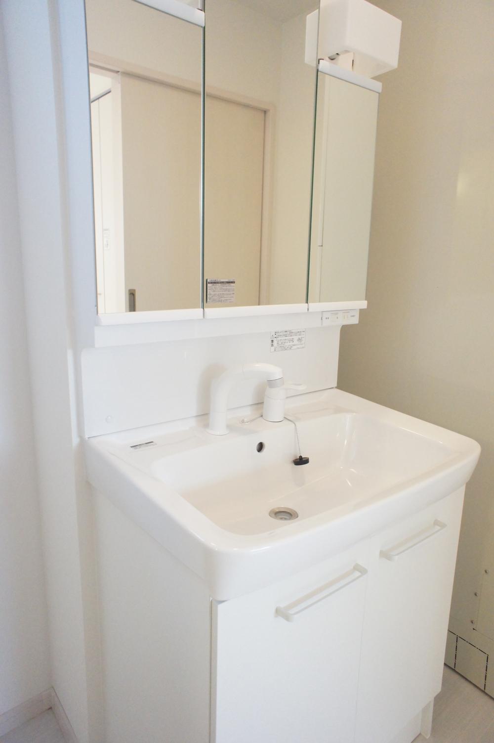 Wash basin, toilet. Washstand that white was the keynote of flawless