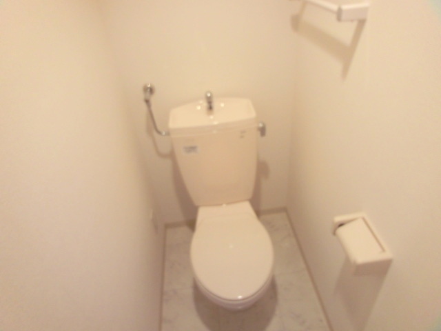 Toilet. It is a photograph of another in Room for in occupancy. 