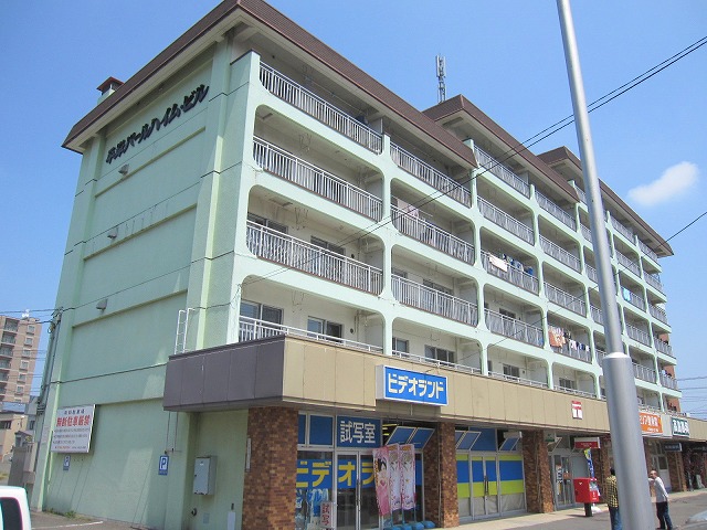 Building appearance. Post office on the first floor, Steak shop, It sweets shop that contains. 