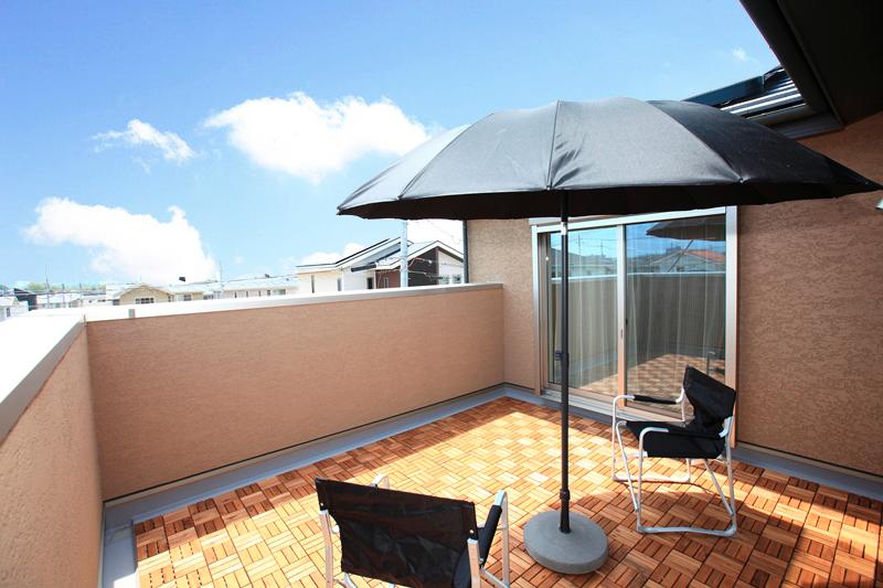 Model house photo. Balcony with a wood deck