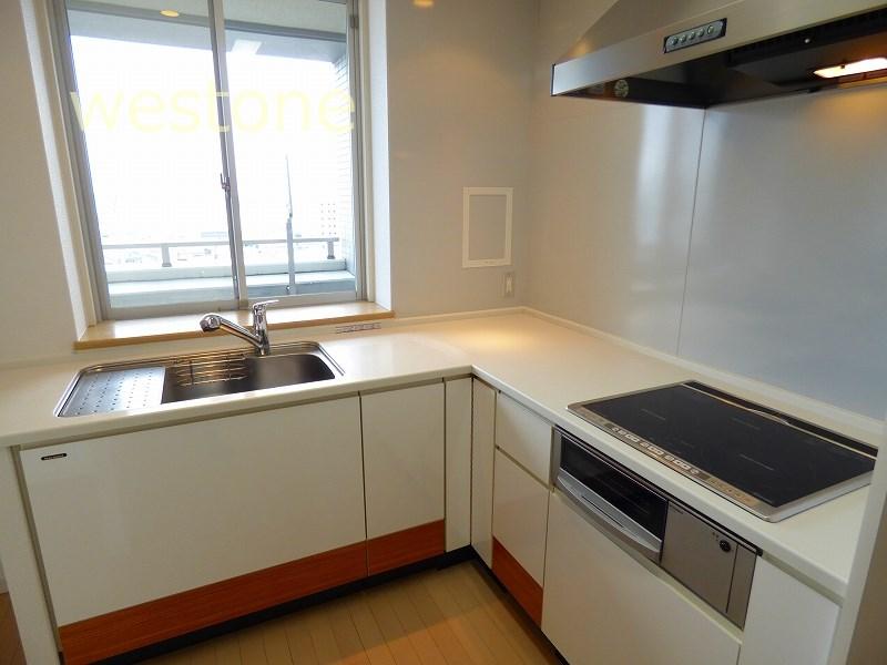 Kitchen. Bright L-shaped kitchen has a window to the front