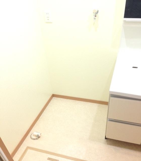 Wash basin, toilet. This washing machine space. 