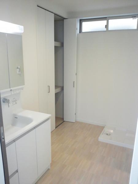 Wash basin, toilet. Wide wash room of with storage! 