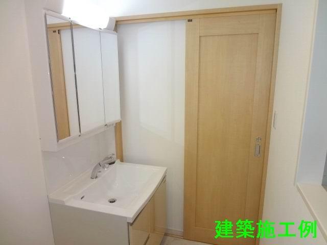 Wash basin, toilet. First floor powder room. Shampoo dresser with a three-way mirror cabinet. Building Construction example. 
