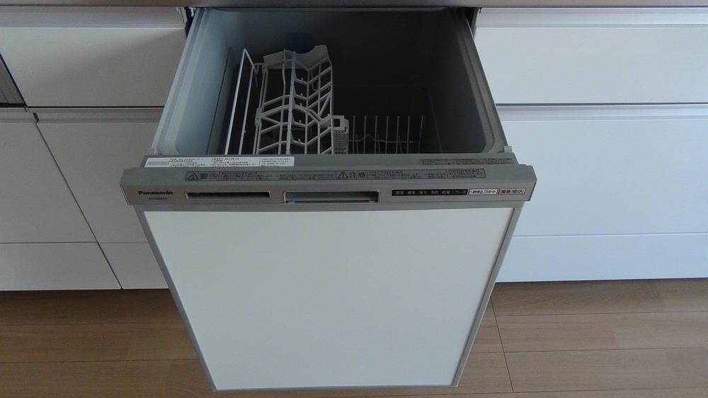 Kitchen. Friendly tableware washing dryer with a kitchen in the hands of the wife 