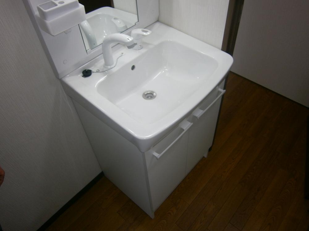 Wash basin, toilet. It is vanity had made of shampoo dresser!