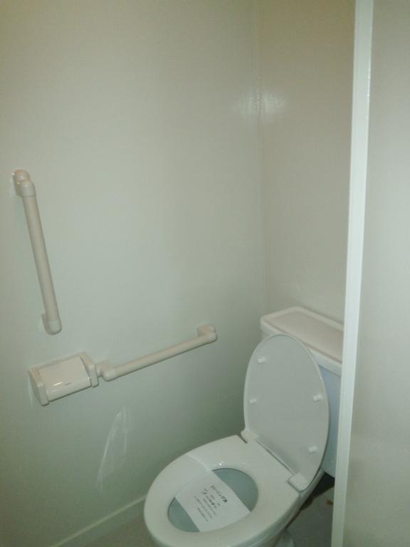 Toilet. A clean toilet with handrail