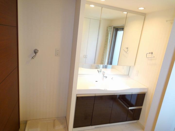 Wash basin, toilet. Vanity is also wide size. It opens onto a balcony.