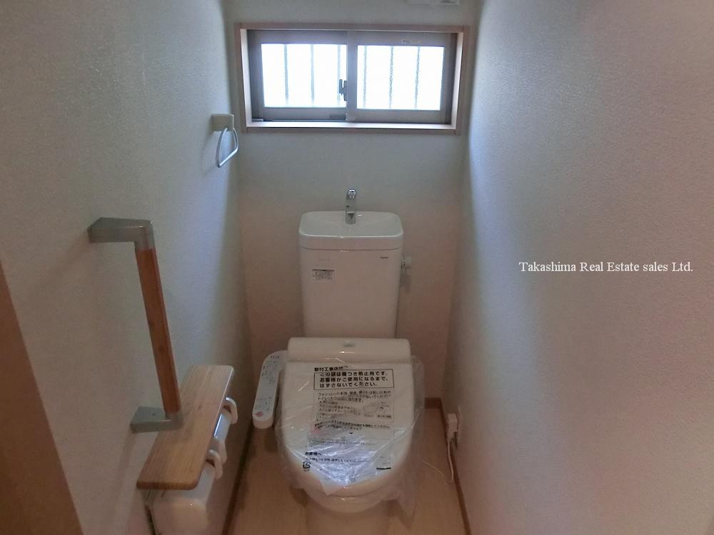 Toilet. It is with a handrail. 