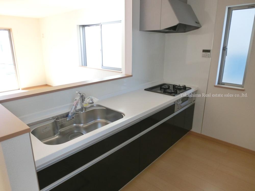 Kitchen. Island is the type of face-to-face kitchen. Storage cabinet is located behind. 