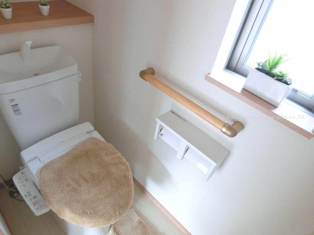 Toilet. Handrail with a toilet.