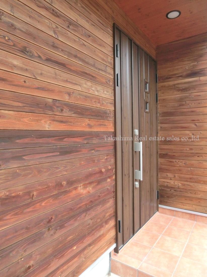 Entrance. Entrance around is decorated with wood grain. It is very fashionable.