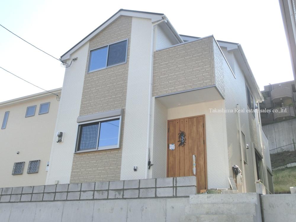 Local appearance photo. New construction has been imposing completed on a hill that can parallel two garage.