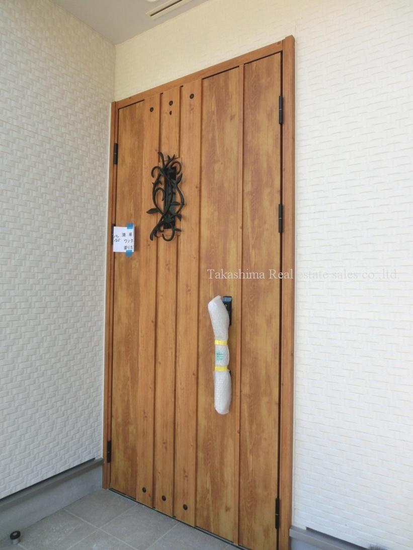Entrance. It is a large parent-child entrance door of woodgrain.