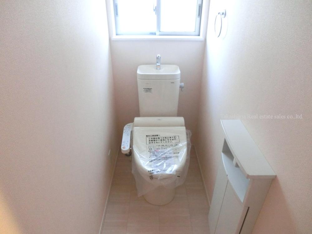 Toilet. It is a compact storage with a toilet room. 