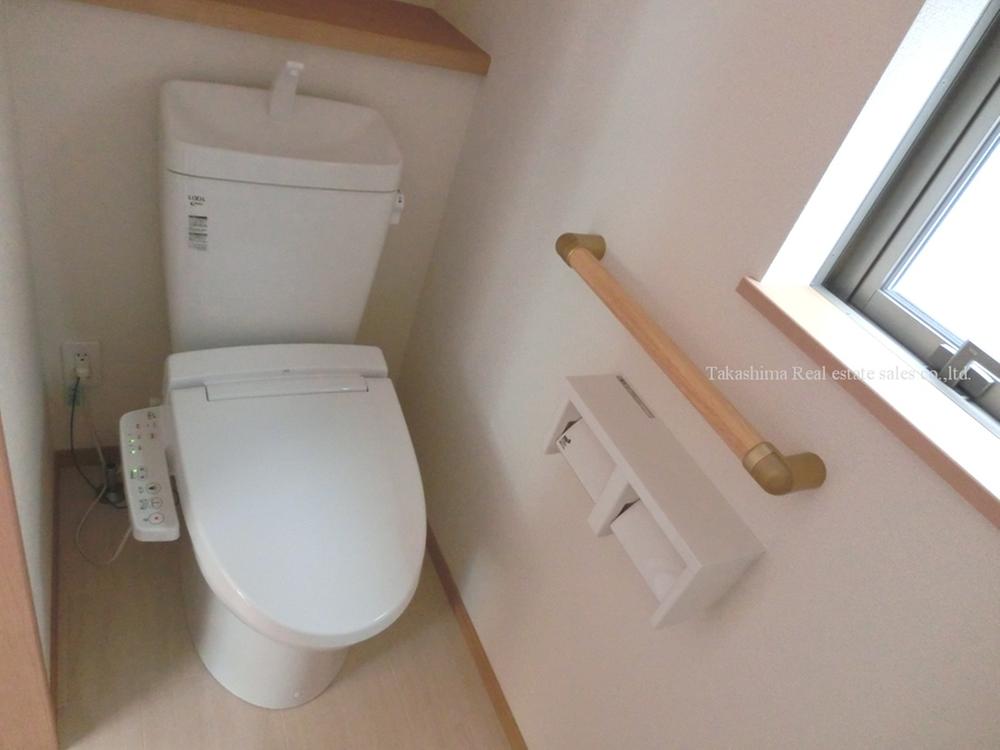 Toilet. Toilet is with a handrail. 