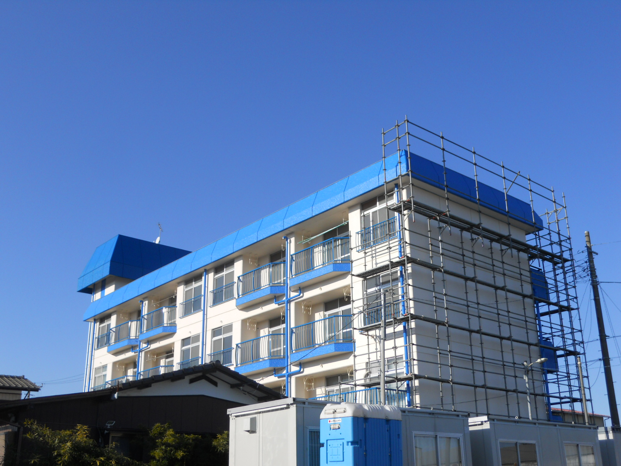 Building appearance. A blue roof cute building. 