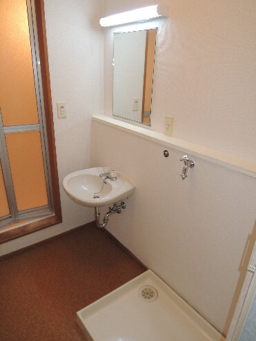 Washroom. Wash basin and washing machine Storage! 