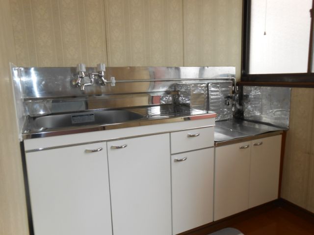Living and room. Bright kitchen has a window on the side.