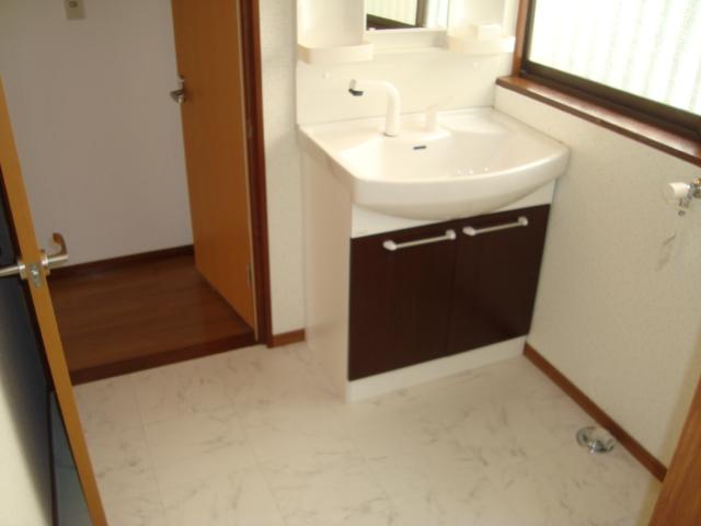 Wash basin, toilet. Undressing room is spacious, Vanity is a new article. Also it has new faucet for washing machine. 